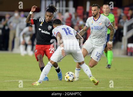 Washington, USA. 25th Sep, 2021. D.C. United forward Yordy Reyna (29) dribbles between FC Cincinnati defender Geoff Cameron (12) and FC Cincinnati defender Ronald Matarrita (18) in the second half at Audi Field in Washington, DC, Saturday, Sept. 25, 2021. United defeated FC Cincinnati 4-2. (Photo by Chuck Myers/Sipa USA) Credit: Sipa USA/Alamy Live News Stock Photo