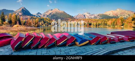Panoramic autumn view of Strbske pleso lake. Picturesque evening scene of High Tatras National Park, Slovakia, Europe. Beauty of nature concept backgr