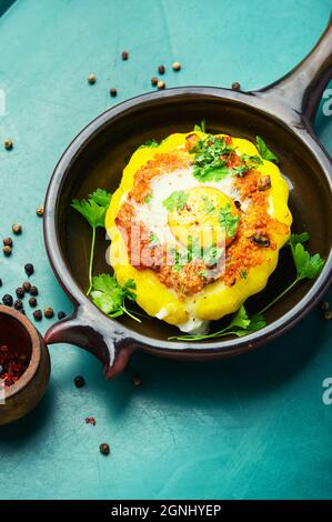 Squash stuffed with couscous and mushrooms. Baked patisson with shakshuka. Stock Photo