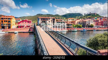 Panoramic spring cityscape of Bosa town with footpath bridge across the Temo river. Picturesque morning view of Sardinia island, Italy, Europe. Travel Stock Photo