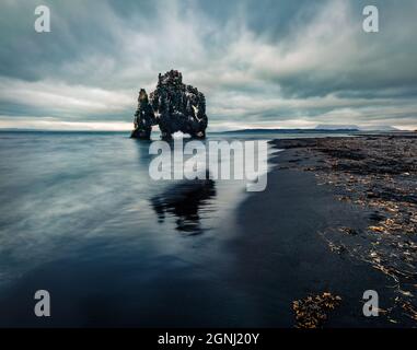 Mistical midnight sun view of huge basalt stack - Hvitserkur. Gloomy summer scene of eastern shore of the Vatnsnes peninsula, Iceland, Europe. Beauty Stock Photo