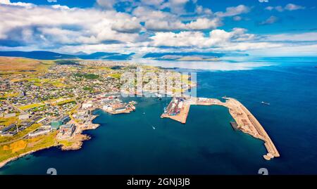 View from flying drone. Breathtaking summer sityscape of Torshavn town. Aerial morning scene of Streymoy island, Faroe, Kingdom of Denmark, Europe. Tr Stock Photo