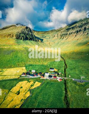 Colorful summer view of Sydradalur village, Kalsoy island. Sunny morning scene of Faroe Islands, Kingdom of Denmark, Europe.  Beauty of nature concept Stock Photo