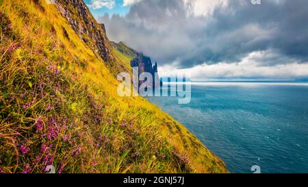 Captivating Faroese landscape with Trollkonufingur cliffs on Vagar island. Gorgeous summer view of outskirts of Sandavagur village, Faroe Islands, Den Stock Photo