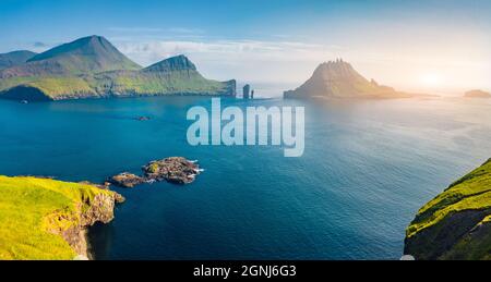 View from flying drone. Magnificent summer scene of Faroe Islands and Tindholmur cliffs on background. Spectacular morning view of Vagar island, Denma Stock Photo