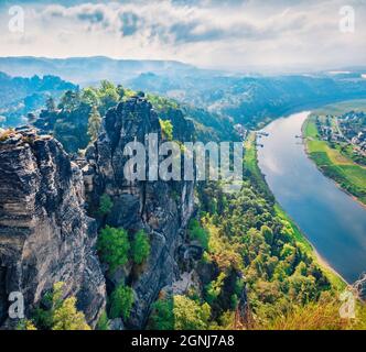 Aerial summer view of Rathen village from viewpoint of Bastei in Saxon Switzerland Germany. Amazing morning scene of Sandstone Mountains, Saxony, Germ Stock Photo