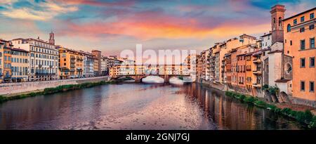Splendid evening view of medieval arched river bridge with Roman origins - Ponte Vecchio over Arno river. Fantastic summer cityscape of Florence, Ital Stock Photo
