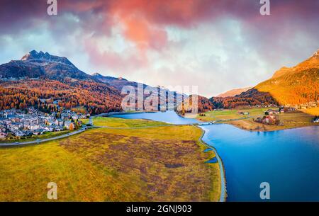View from flying drone. Amazing autumn scene of Silvaplana village, Maloja Region. Aerial morning view of Swiss Alps. Spectacular evening landscape of Stock Photo