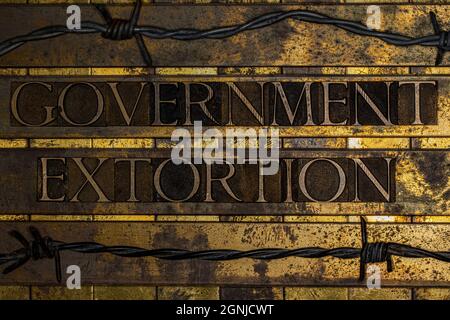 Government Extortion text on textured grunge copper and vintage gold background Stock Photo