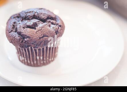 Close up double chocolate muffin delicious desert bakery on white ceramic plate. Stock Photo
