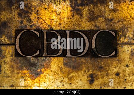 CBDC text on textured grunge copper and vintage gold background Stock Photo