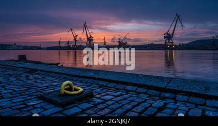 Gothenburg , Sweden - February 27 2015: Cranes of and old wharf in a beautiful sunset. . Stock Photo