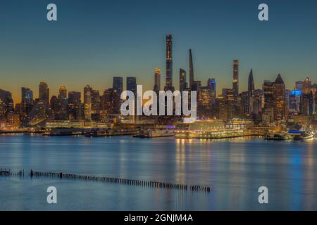 The Manhattan skyline in New York City during morning twilight as viewed over the Hudson River from New Jersey. Stock Photo