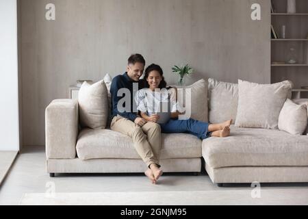 Happy loving young family couple using digital tablet. Stock Photo