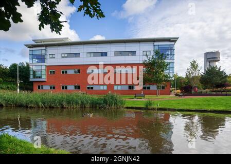 Daresbury Science Park Innovation Centre building and tower, formerly Daresbury Nuclear Physics Laboratory, seen alongside the Bridgewater canal near Stock Photo