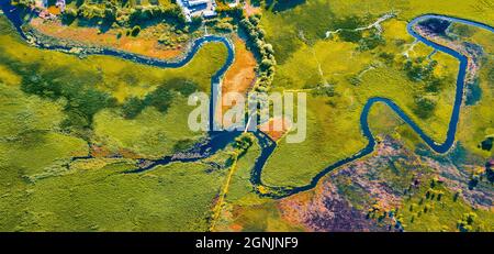 Straight dawn panoramic view from flying drone of bridge over Seret river, Ternopil region, Ukraine, Europe. Exciting summer scene of green flooded va Stock Photo