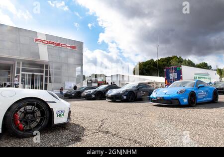 Vallelunga, italy september 19th 2021 Aci racing weekend. Many Prosche cars standing in front of showroom building Stock Photo