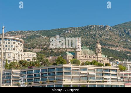 Monaco, Monaco - July 08 2008: Hotel de Paris and Casino de Monte-Carlo with tall mountains in the backgroud Stock Photo