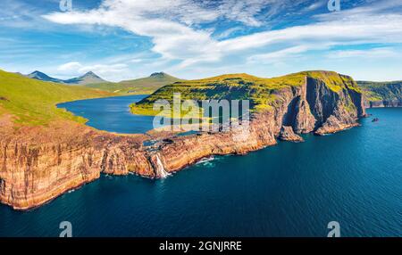 Panoramic view from flying drone of Bosdalafossur waterfall, that falls directly into the ocean. Impressive summer scene of Sorvagsvatn lake, Vagar, F Stock Photo