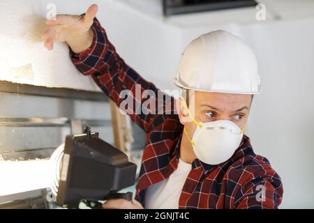 construction worker thermally insulating eco-friendly homes Stock Photo