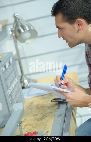 factory man worker taking notes Stock Photo
