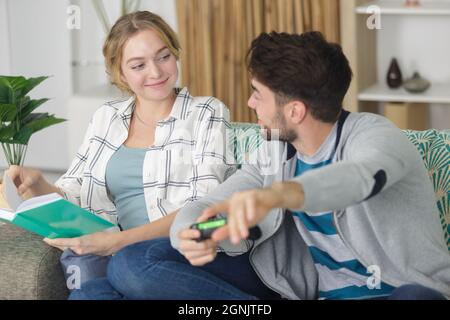 happy married couple spend time sitting on couch Stock Photo