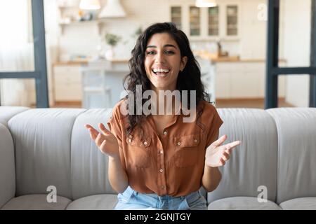 Headshot of happy young woman speaking to her friend on computer webcam, communicating remotely from home Stock Photo