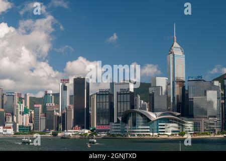 Star Ferries travel across Victoria Harbour between Tsim Sha Tsui pier in Kowloon and Wan Chai, Hong Kong Island Stock Photo