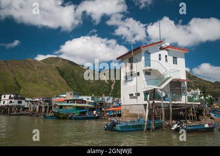 A modern village house on a concrete base among stilt houses ('pang uk') in Tai O, Lantau Island, Hong Kong Stock Photo