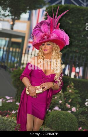 Fabulous lady wears an eye catching dress with a fancy hat on Ascot Ladies Day Stock Photo Alamy