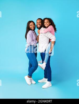 African American dad giving piggyback ride to his daughter Stock Photo