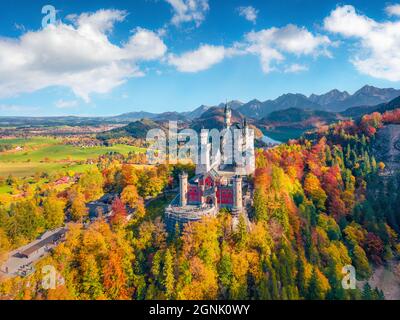 Aerial landscape photography. Adorable autumn view from flying drone of Neuschwanstein Castle, 19th-century hilltop fairytale castle. Wonderful mornin Stock Photo