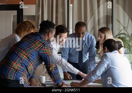 Busy diverse business team working on project together Stock Photo