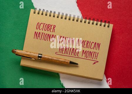 October - National Italian American Heritage Month, handwriting in a spiral notebook against paper abstract in colors of national flag of Italy (green Stock Photo