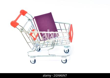 blue cover book carrying on shopping cart in white background Stock Photo