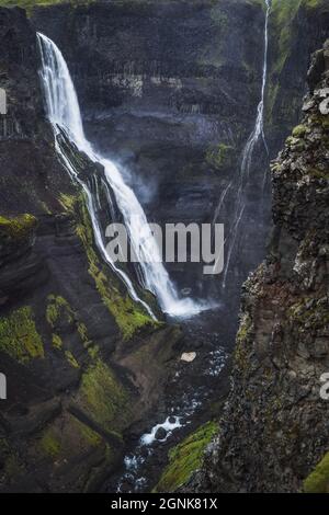 Haifoss waterfall in South Iceland in the dusk. Beautiful nature dramatic moody landscape. Vertical view Stock Photo