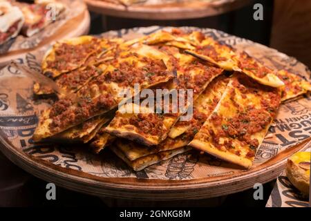 turkish pizza pide with meat, cut into pieces. Stock Photo