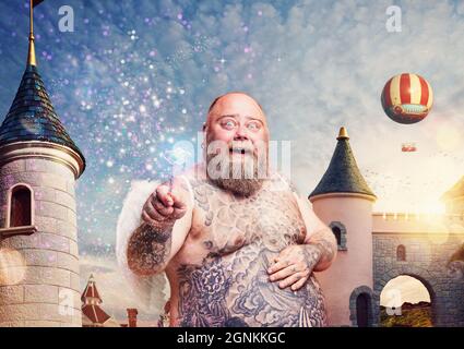 Fat angel with magic wand makes a spell Stock Photo