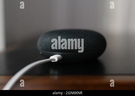 Paris, France - 20 September , 2021: Black physical microphone switch button of the Google Home Mini Stock Photo