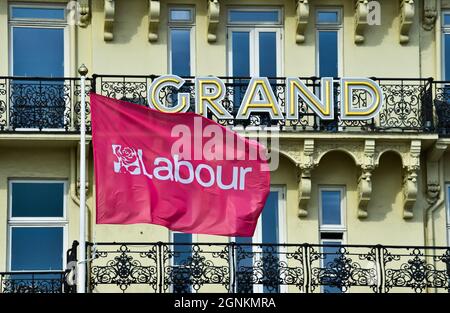 Brighton UK 26th September 2021 -  A Labour Party flag flies outside the Grand Hotel during the Labour Party Conference   : Credit Simon Dack / Alamy Live News Stock Photo