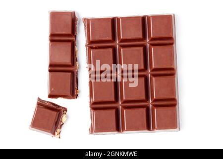 Chocolate bar with nuts and broken pieces isolated on white Stock Photo
