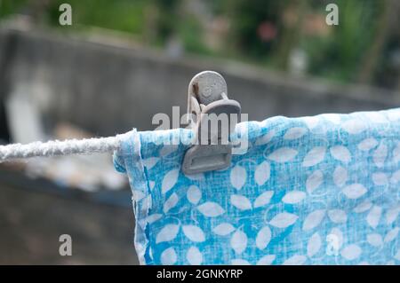 Clothespins hanging on a cloth rope outside laundry. Close up. Stock Photo