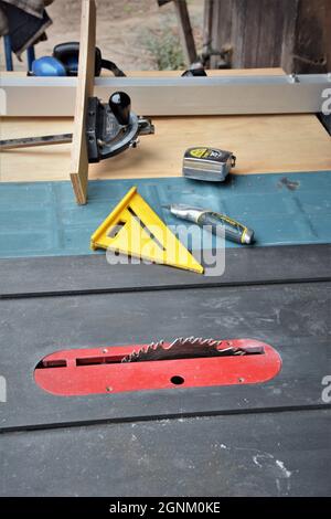 Do It Yourself senior men and Home owners cutting an preparing laminate flooring for their home using saws, planes and other tools which are dangerous Stock Photo