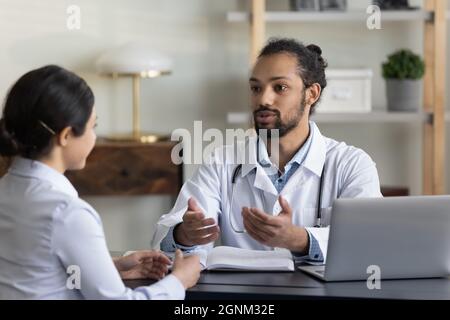 Young male doctor giving consultation, advice, recommendation Stock Photo