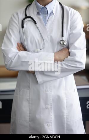 Cropped view of female general practitioner wearing white coat Stock Photo