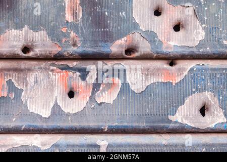 rusty and scratched metal panel background with bullet holes Stock Photo
