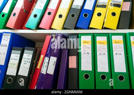 London. UK- 09.13.2021: Shelves full of well used office files of various function and sizes. Stock Photo