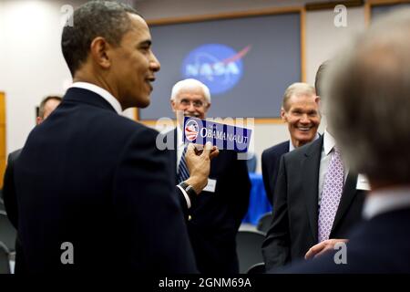 President Barack Obama is given an 'I'm an Obamanaut' bumper sticker at NASA operations at the Kennedy Space Center in Cape Canaveral, Fla., April 15, 2010. (Official White House Photo by Pete Souza) This official White House photograph is being made available only for publication by news organizations and/or for personal use printing by the subject(s) of the photograph. The photograph may not be manipulated in any way and may not be used in commercial or political materials, advertisements, emails, products, promotions that in any way suggests approval or endorsement of the President, the Fir Stock Photo