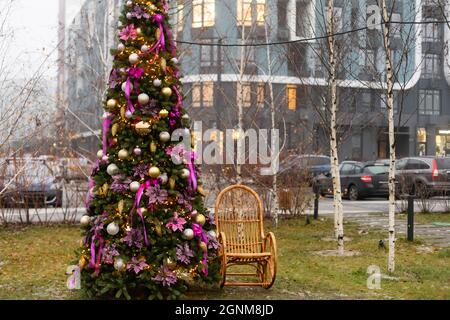 Cozy decor for Christmas and New Year. New Year's Concept. Christmas photo. Christmas scenery photo zone: chair rocking chair, Christmas tree Stock Photo