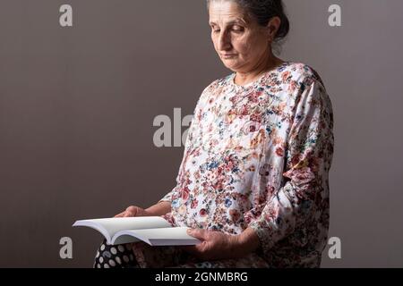 Senior woman reading a book, editable mock-up series template ready for your design. cover and pages selection path included. Stock Photo